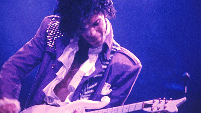 Prince playing electric guitar in the 1980s
