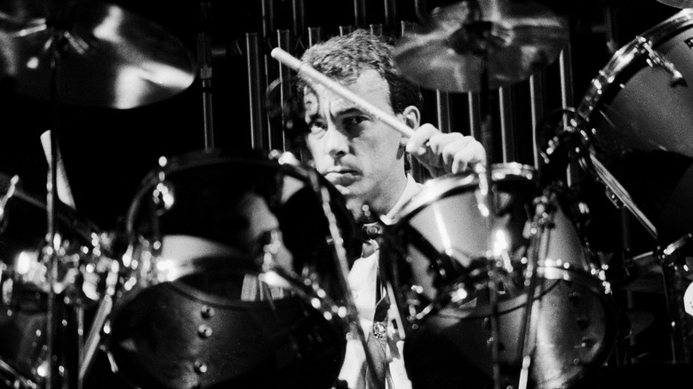 Neil Peart peaking through drum kit