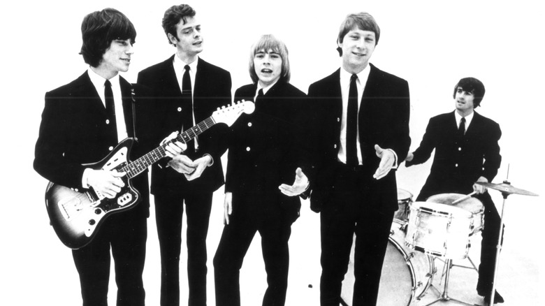 The Yardbirds posing for a band photo, with Jeff Beck on the left, holding a guitar.