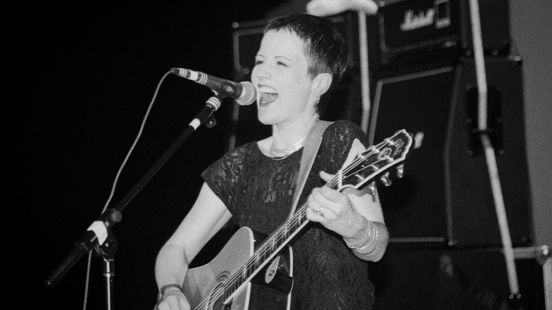 Dolores O'Riordan of the Cranberries performing with guitar on stage