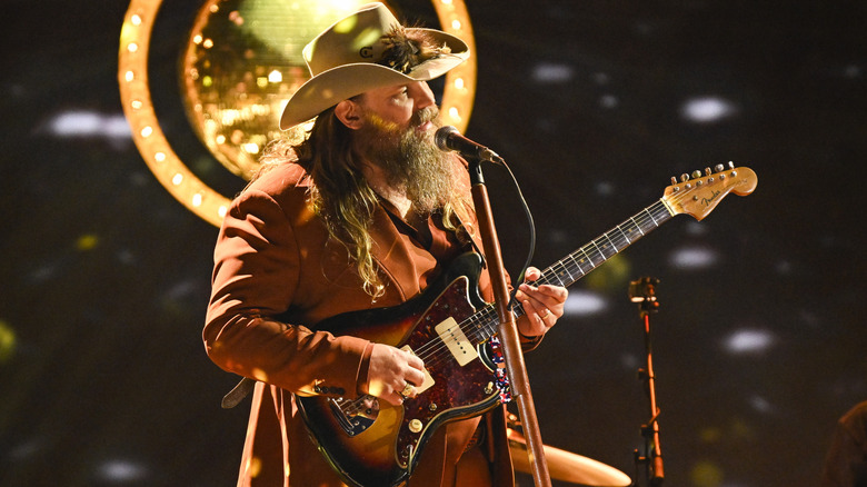 Chris Stapleton playing guitar live in concert