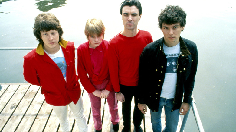 The Talking Heads posing for a photo standing on a pier.