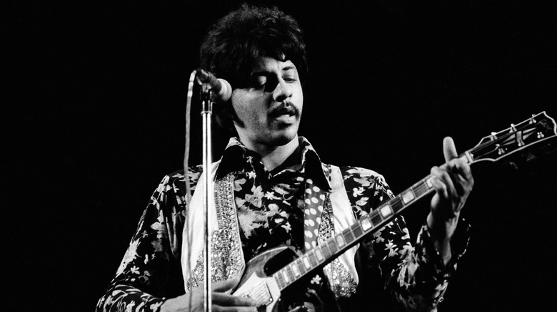 Arthur Lee of Love playing guitar and singing on stage