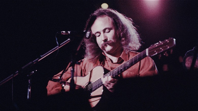 David Crosby playing guitar during live performance