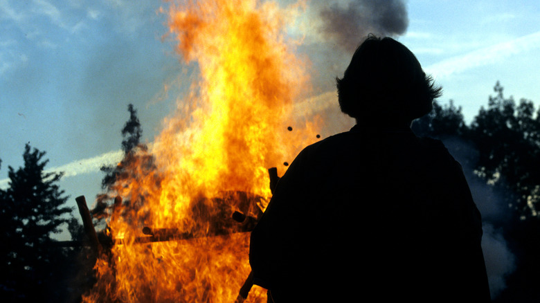Observer watching open-air cremation