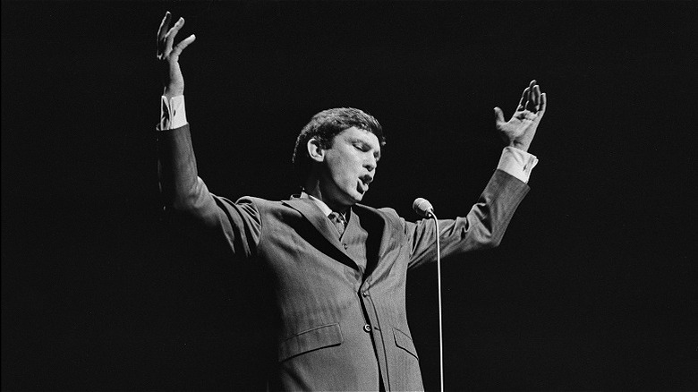 Gene Pitney singing with arms up