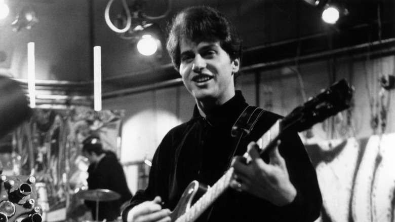 Johnny Rivers smiling with guitar