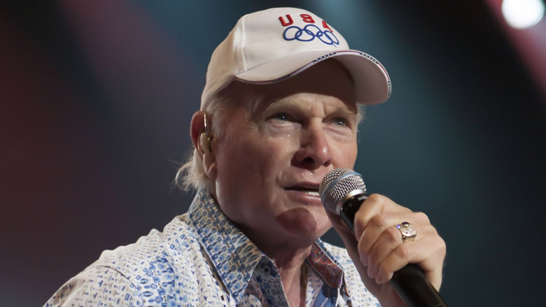 Mike Love singing into a microphone