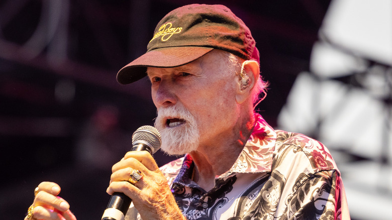 Mike Love singing into a microphone