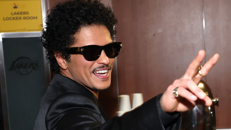 Bruno Mars giving peace sign in sunglasses