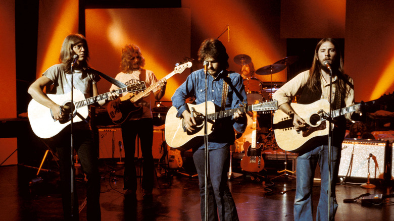 America playing with guitars on stage in 1970s