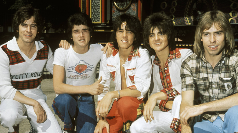 Bay City Rollers crouching and smiling together