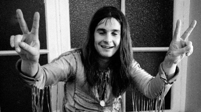 Ozzy Osbourne flashing the peace sign in 1971