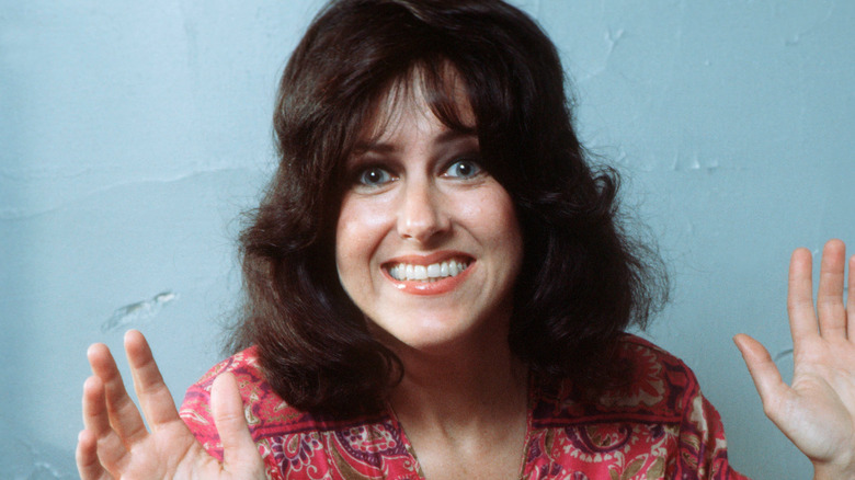 Grace Slick smiling with hands raised