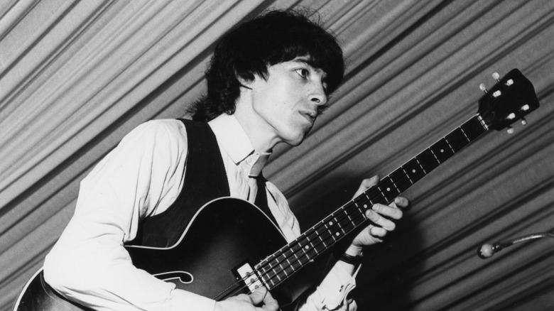 Bill Wyman playing acoustic guitar