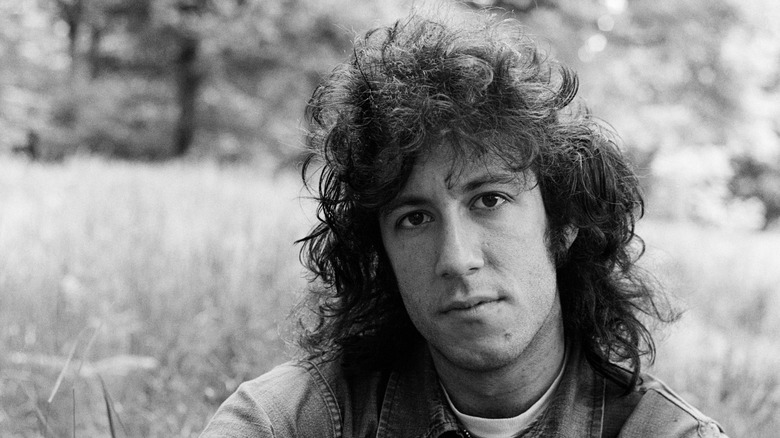Peter Green of Fleetwood Mac sat in a field
