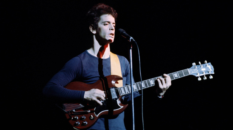 Lou Reed with guitar onstage