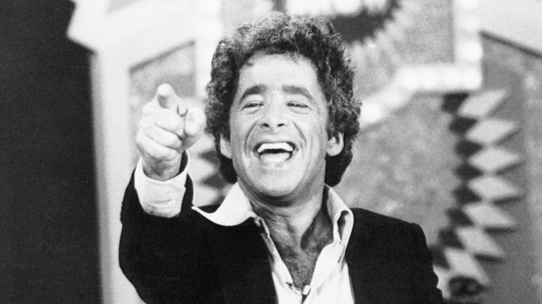 Chuck Barris pointing and laughing on The Gong Show set