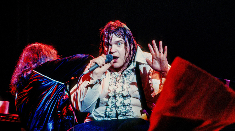 Meat Loaf on stage in tuxedo shirt looking up and away