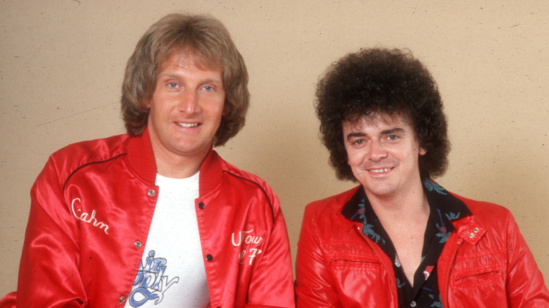 Air Supply members in matching red windbreakers