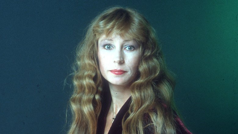 Juice Newton smirking at camera