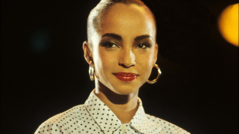 Sade Adu smiling with mouth closed