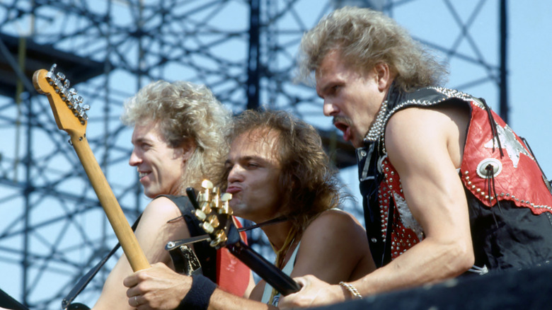 Scorpions playing guitar on stage and making funny faces