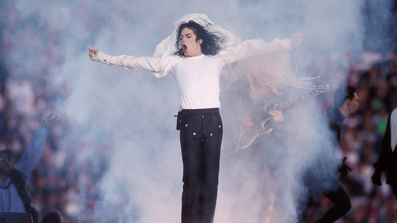 Michael Jackson arms out, performing at the Super Bowl