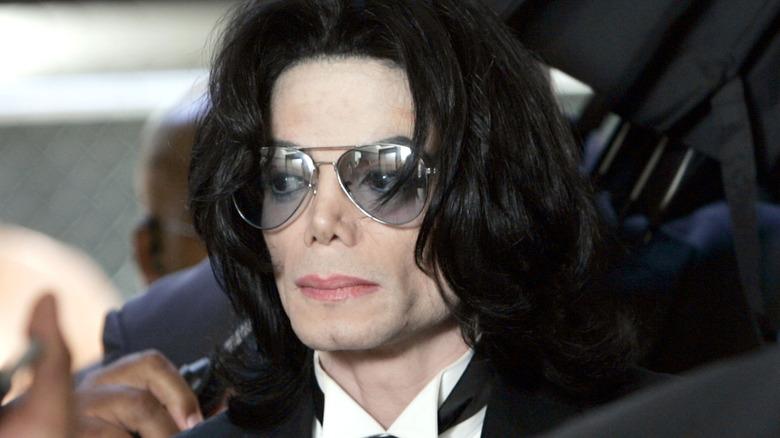 Michael Jackson in dark glasses leaving his trial
