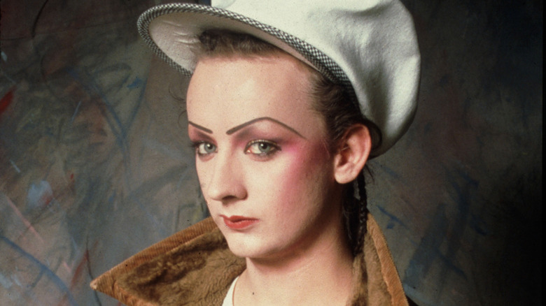 Boy George in big hat glaring at camera in 1980s