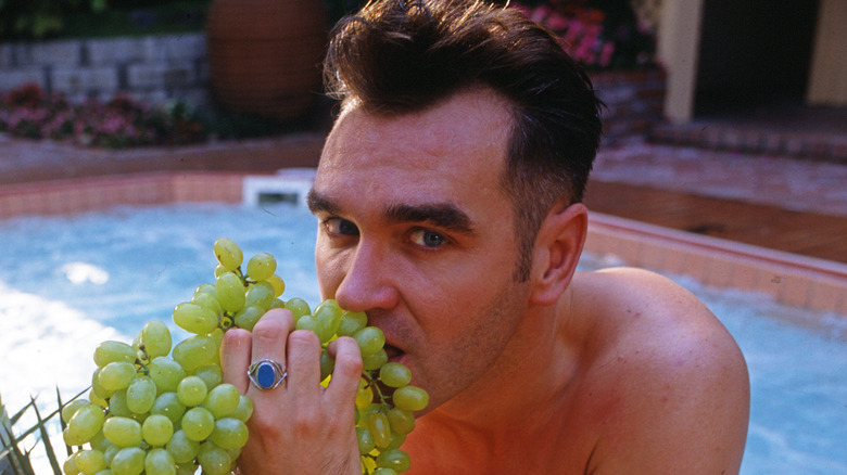 Morrissey eating grapes in a hot tub