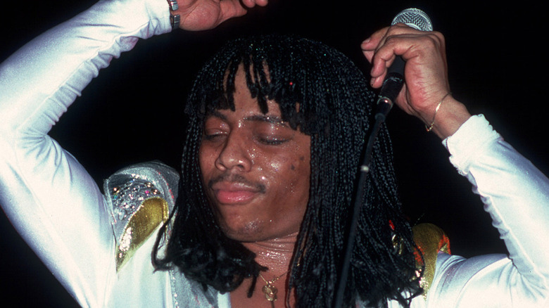 Rick James dancing on stage in jumpsuit with eyes closed