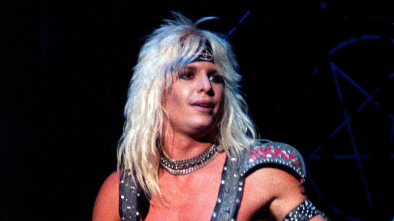 Vince Neil on stage in 1980s looking to side