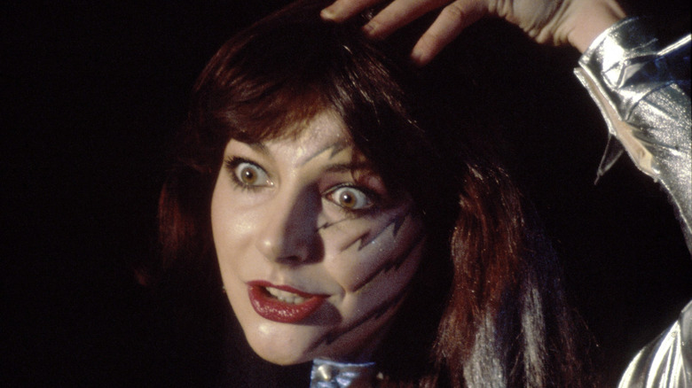 Kate Bush performing wide-eyed in face paint