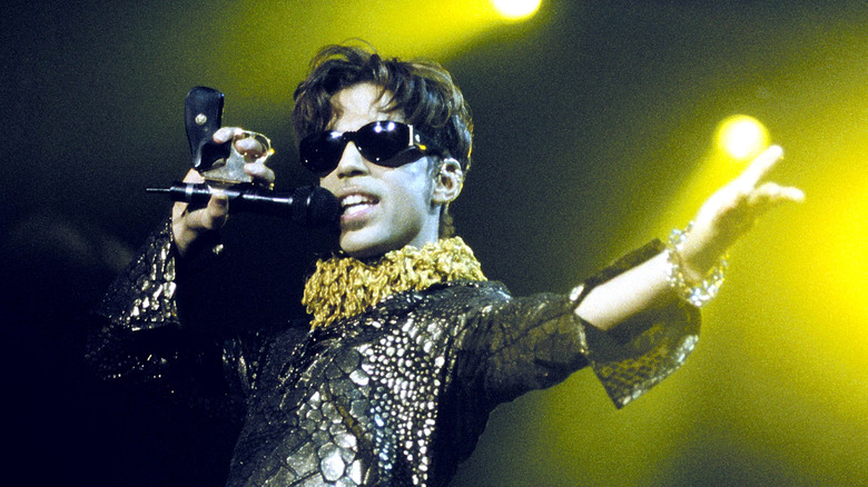 Prince wearing sunglasses while performing onstage