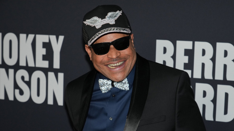 Rockwell wearing sunglasses smiling at an event
