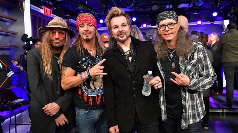 members of Poison posing for photo