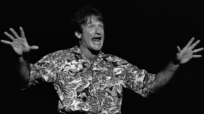 Robin Williams waving hands onstage