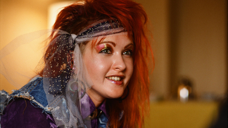 young woman absolutely rocking out on headphones