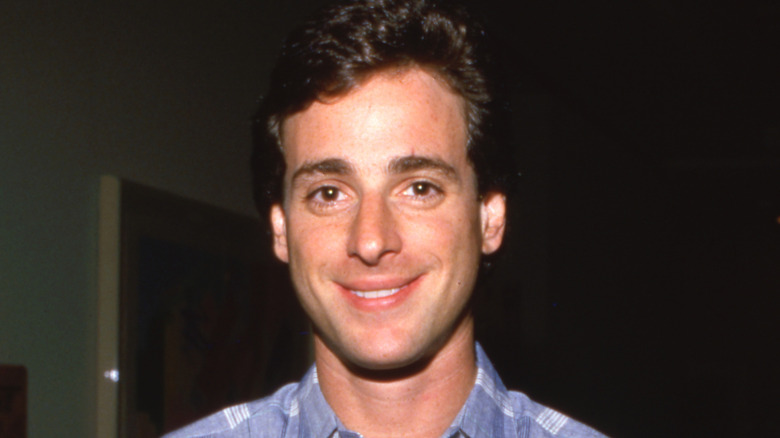 Bob Saget grinning in blue shirt