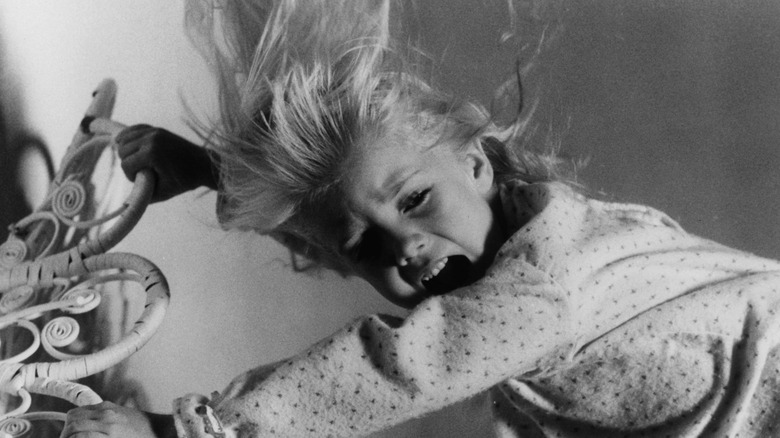 Heather O'Rourke getting pulled by spirits in still from Poltergeist