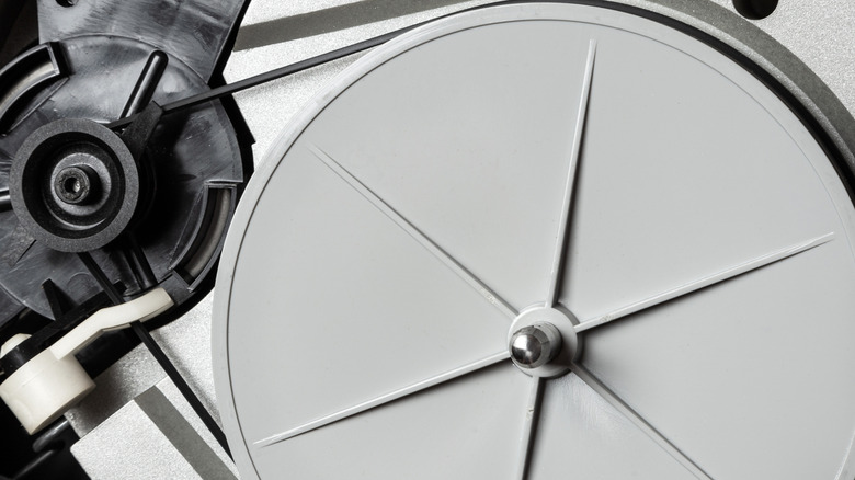 The underside mechanism of a belt-drive turntable