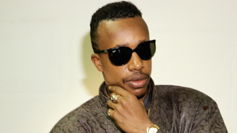 MC Hammer in sunglasses touching cheek