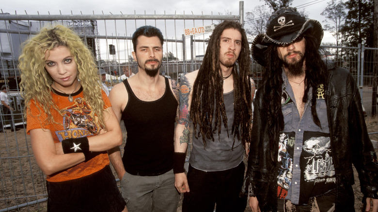 White Zombie glares at camera in front of fence