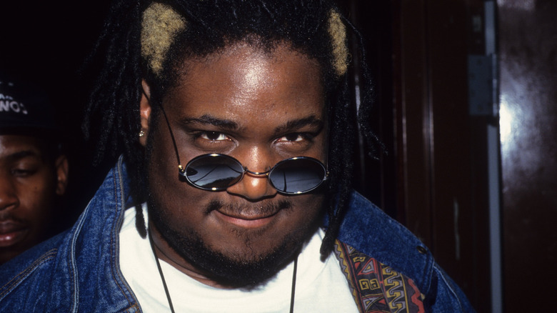 Prince Be smiling and looking out over sunglasses