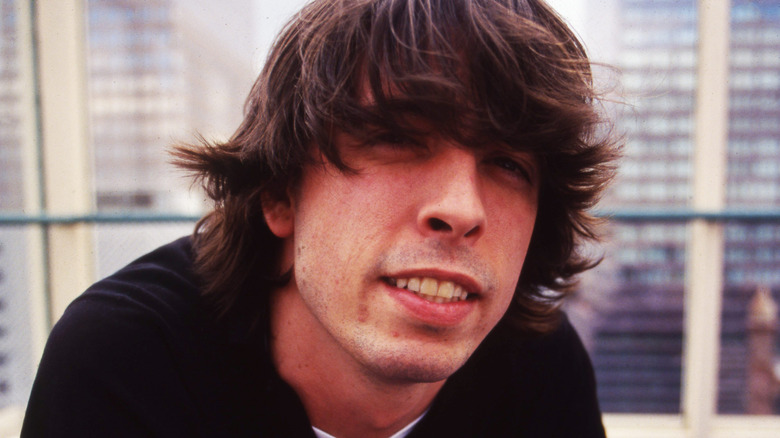 Dave Grohl smiling with long hair in 1998