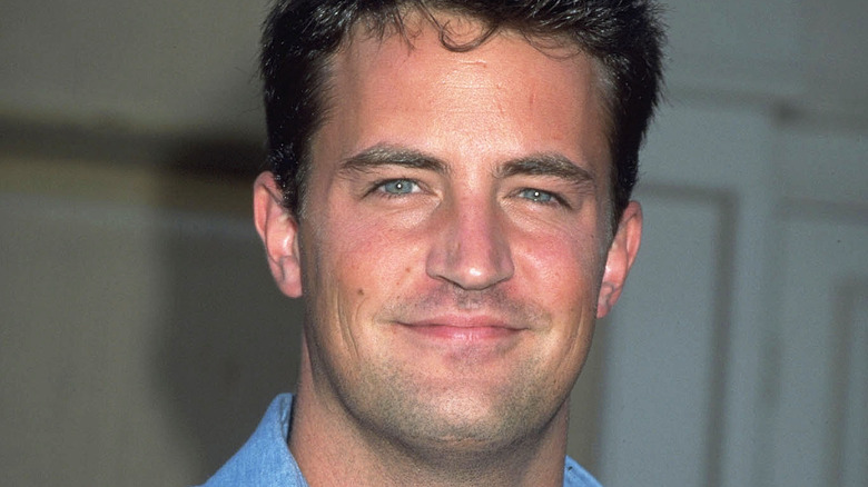 Matthew Perry blue shirt grinning