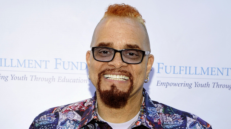 Sinbad smiling in glasses and goatee at event