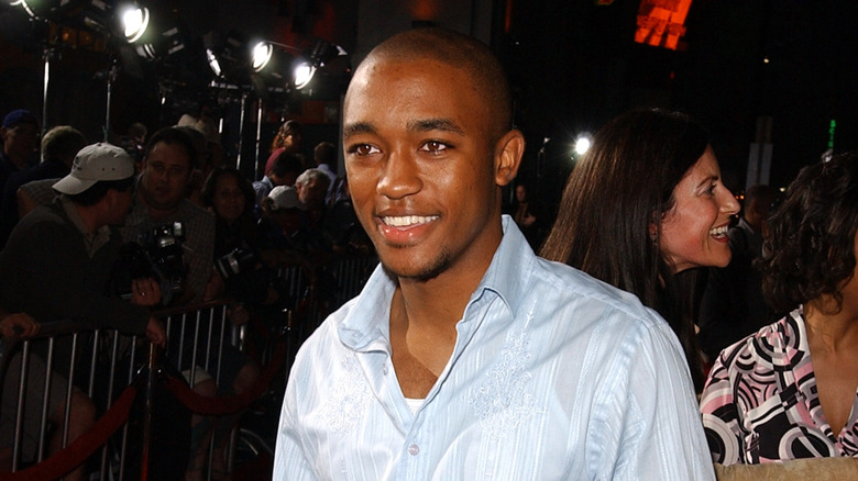 Lee Thompson Young posing on the Friday Night Lights red carpet and smiling