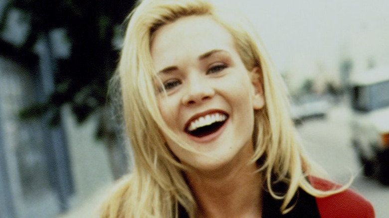 Amy Locane smiling on set of Melrose Place in '90s